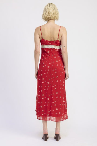 Red floral dress worn by a person on a white background