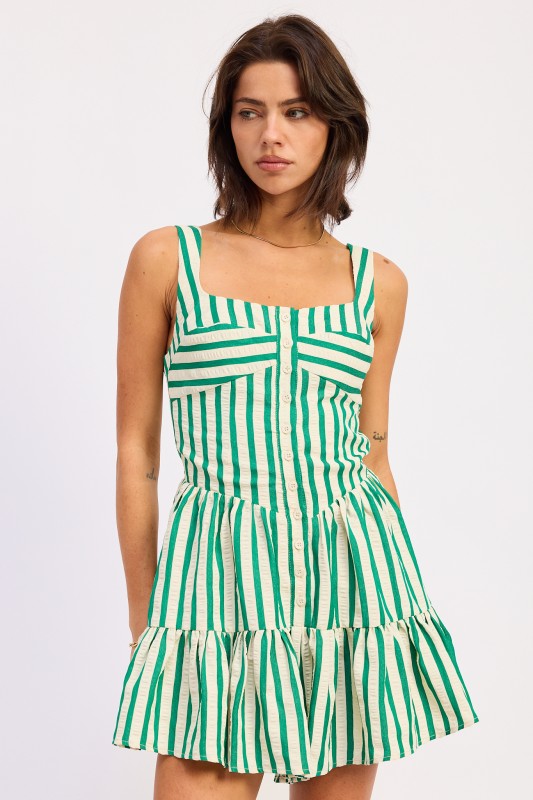 Woman wearing a green and white striped dress on a white background