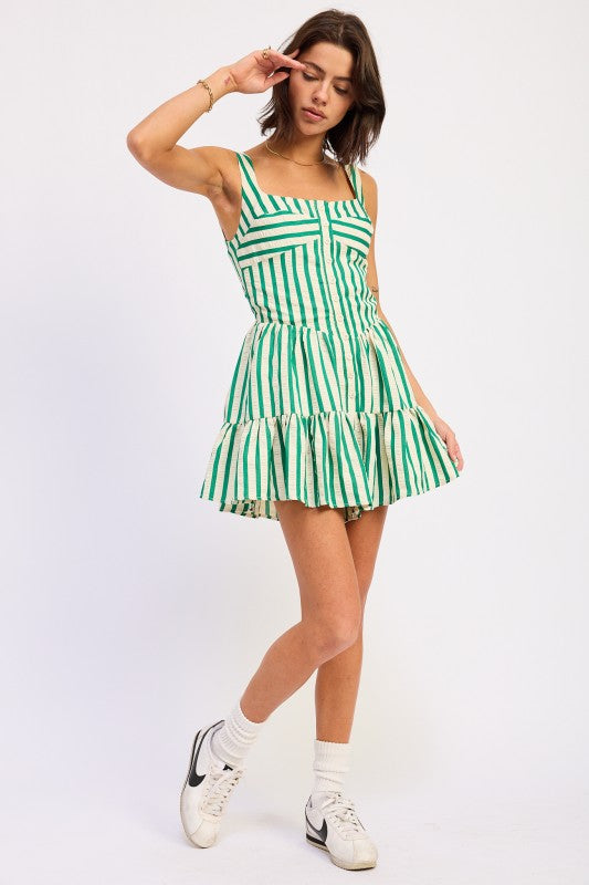 Woman wearing a green and white striped dress on a white background
