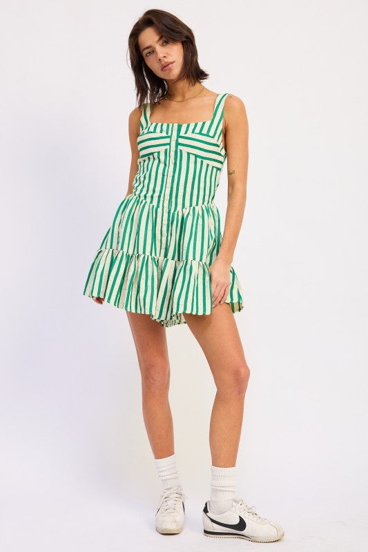 Woman wearing a green and white striped dress on a white background