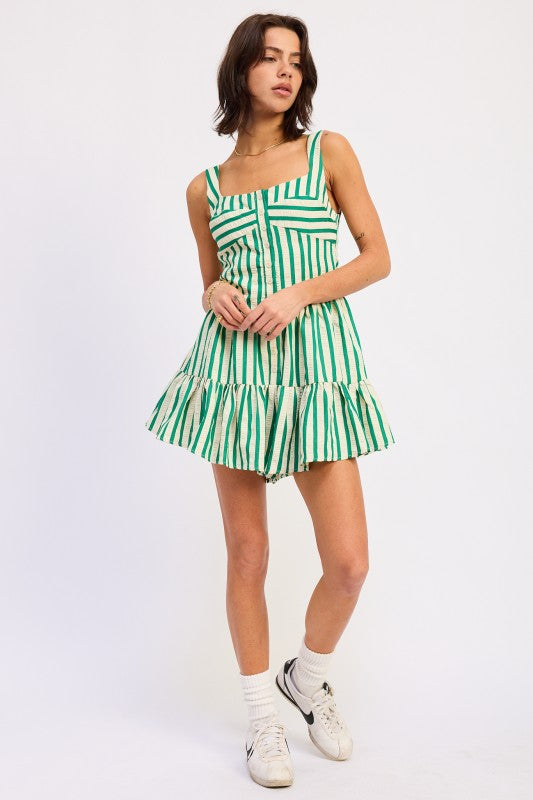 Woman wearing a green and white striped dress on a white background