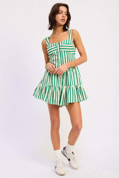 Woman wearing a green and white striped dress on a white background